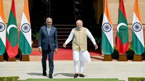 India's Prime Minister Narendra Modi (R) and Maldives President Mohamed Muizzu walk before their meeting at the Hyderabad House in New Delhi on October 7, 2024. Maldives President Mohamed Muizzu was given a red carpet welcome on his first state visit to India on October 7, a trip aimed at repairing frail ties between the South Asian neighbours. (Photo by Money SHARMA / AFP) (Photo by MONEY SHARMA/AFP via Getty Images)