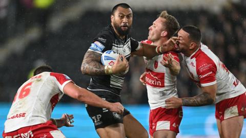 Hull FC forward Ligi Sao is tackled by three Hull KR players