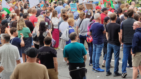 Hundreds of protestors outside the FM's home