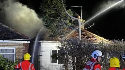 The emergency services were called to the blaze in Hundred Road, March, near Ely, at about 18:00 GMT