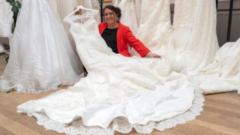 Sidcup charity shop manager Sally Todd surrounded by donated wedding dresses