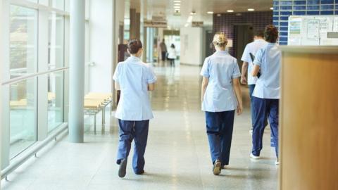 Nurses walking along a hospital corridor