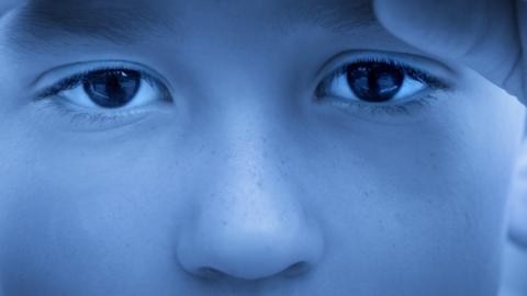 Stock image - close up of a child's eyes looking sad