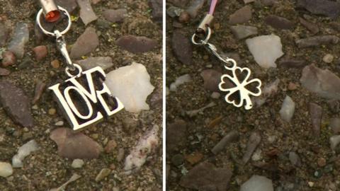 Two charms - a shamrock and one which says 'love'