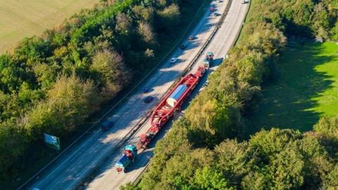 Large piece of power equipment being transported 