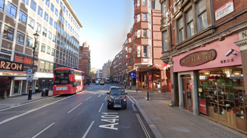 A Google Streetview image of Shaftesbury Avenue, with a bus going one way and taxi going the other