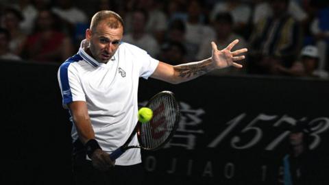 Daniel Evans hits a return