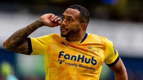 Nathaniel Mendez-Laing points to his ear in celebration at scoring for Derby County
