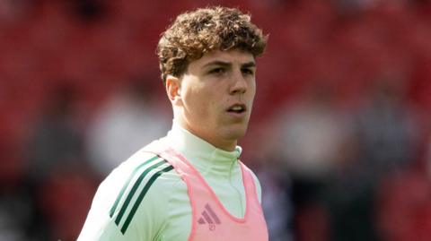 Celtic midfielder Arne Engels warming up