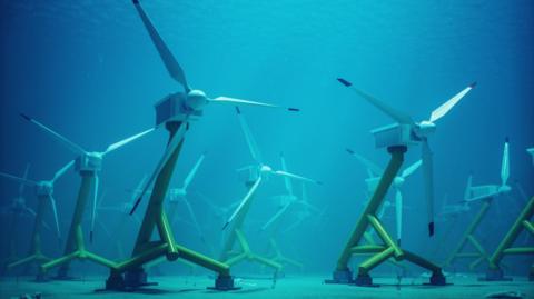 A stock image of an array of turbines standing on the sea bed