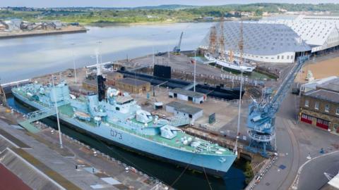 Aerial shot of historic ships and submarine in dry docks at Historic Dockyard Chatham with River Medway in background