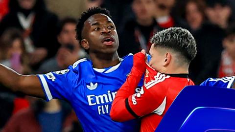 Real Madrid's Vinicius Junior reacts to alleged racist abuse from Benfica's Gianluca Prestianni in the Champions League