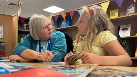 Bronwen Gamble conducting a one-to-one reading session with a pupil in a Nottingham school.