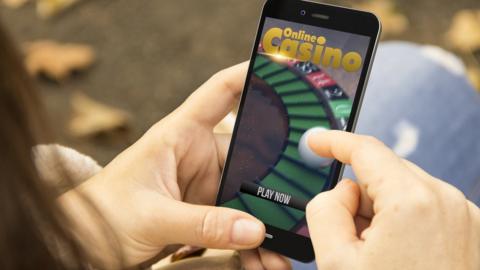 A woman using an online gambling website on her smartphone