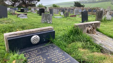 A graveyard with the stones lying down.