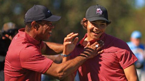 Tiger Woods of the United States reacts with his son Charlie Woods after holing out on the fourth hole during the second round of the PNC Championship at Ritz-Carlton Golf Club in Orlando, Florida