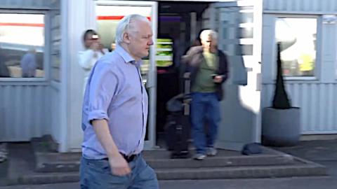 Julian Assange walking at Stansted Airport