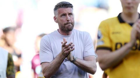 Rob Edwards applauds the fans