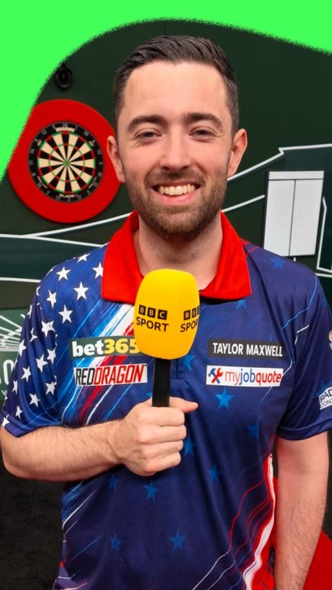 Luke Humphries holding a BBC Sport microphone