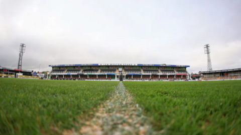 General view of Edgar Street stadium from the middle of the pitch. Seats and advertisement boards can be seen in the background.