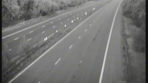 A blurry picture from a traffic camera which shows an empty motorway between junctions 12 and 13.
