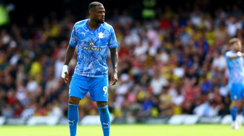 Cyle Larin looks on while playing in Southampton's blue kit away to Watford on the opening day of the Championship season