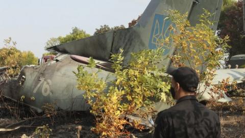 Rescuers inspect the crash site of the An-26 plane near Kharkiv, Ukraine, on 26 September 2020