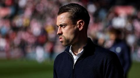 Tonda Eckert looks on from the sidelines
