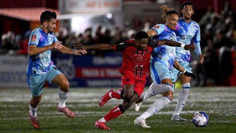 Beck-Ray Enoru of Tamworth tries to dribble through the Leyton Orient defence