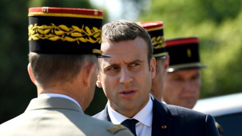 French President Emmanuel Macron (C) speaks to an official during a ceremony marking to mark the 77th anniversary of General Charles de Gaulle"s appeal of 18 June 1940, at the Mont Valerien memorial in Suresnes, near Paris, France, 18 June 2017