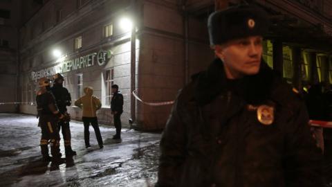 Russian police officers and Emergency Ministry members outside a supermarket after an explosion,