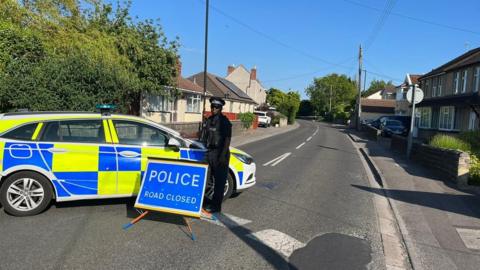 Police standing at Worle High Street, in Somerset,