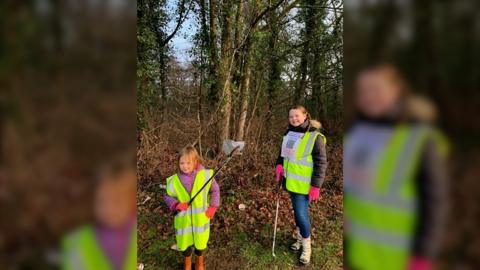 Two children litter picking