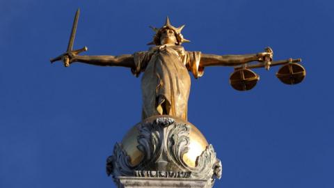 Statue of Justice stands atop the Central Criminal Court building, Old Bailey, London
