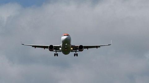 A commercial plane flying in the sky.