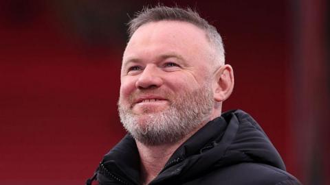 Wayne Rooney smiles at the Liverpool v Paris St-Germain Uefa Champions League quarter-final in 2026