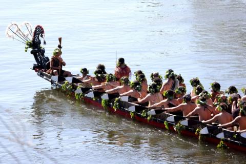 Maori warriors wait in a waka canoe to carry the remains of Māori King Tuheitia Pootatau Te Wherowhero VII down the Waikato river in Hamilton, New Zealand