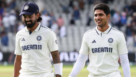 KL Rahul, wearing a cap, and Shubman Gill, smiling, walk off at the end of day four