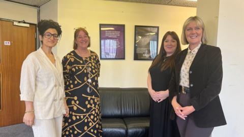 Police and Crime Commissioner Joy Allen with Yasmin Khan standing inside an office with two other women.