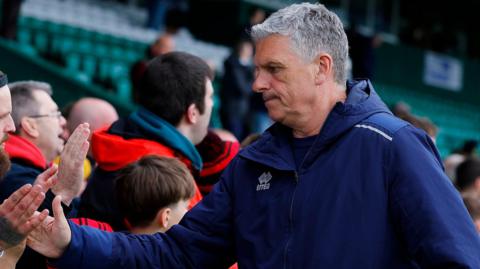 John Askey shakes supporters' hands