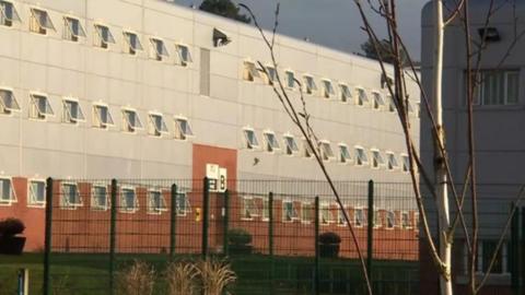 The outside of HMP Parc with a fence seen around it.