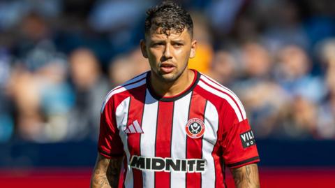 Gus Hamer, wearing Sheffield United's red and white home shirt during a pre-season friendly against Bochum