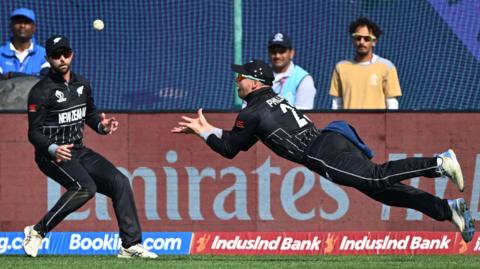 New Zealand's Glenn Phillips dives full length to take a catch