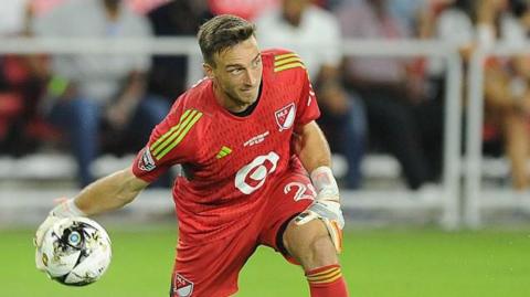 Tyler Miller about to roll the ball out underarm during a match for DC United 