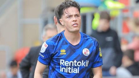 Louie Watson in blue Crawley Town shirt