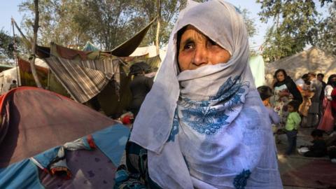 A woman cries as she talks about her son who was killed by the Taliban as displaced Afghans arrive at a makeshift camp in Kabul, Afghanistan.