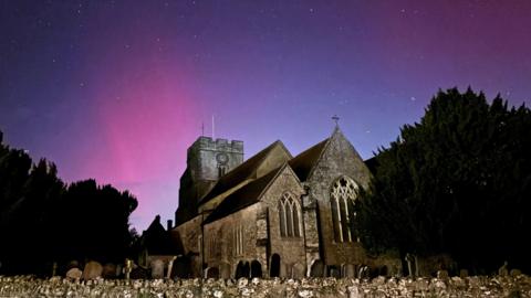 Northern Lights on display in the skies over Great Chart Church, Ashford, Kent