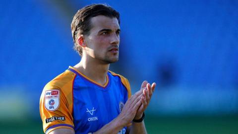 Tom Sang claps the Shrewsbury Town crowd after a game