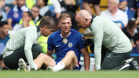 Liam Delap sits and receives injury treatment