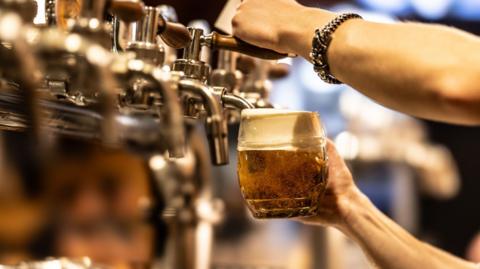 A beer being pulled in a pub